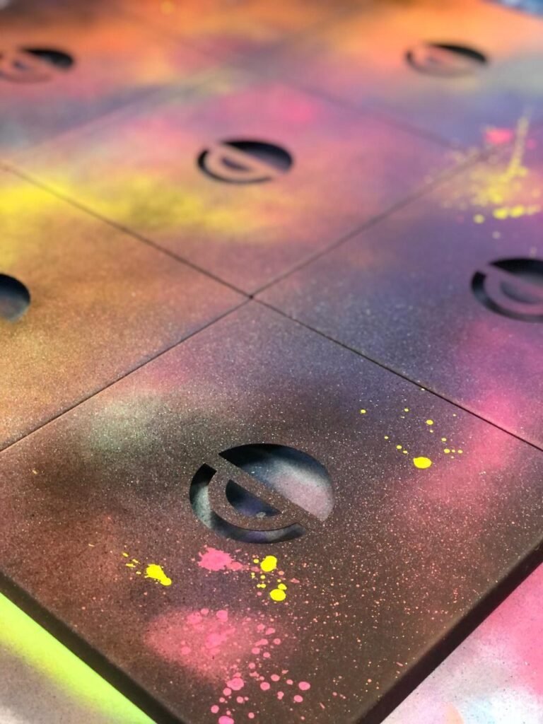 Símbolo da Caderode pintado em degradê rosa e amarelo sobre o painel